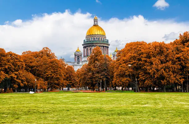 Photo of Famous St. Isaac Cathedral on autumn day. Picturesque view from the Senate Square on summer day. Saint-Petersburg, Russia