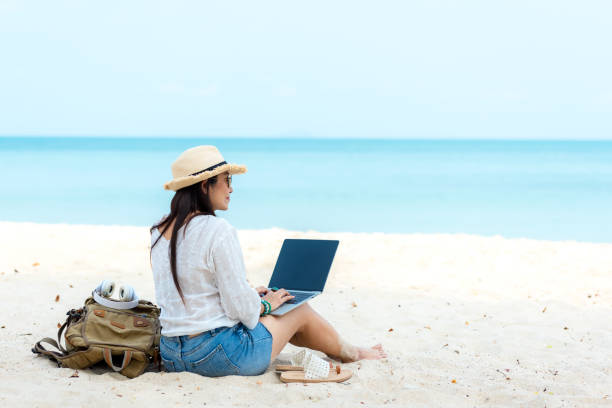 istock Lifestyle freelance man using laptop working and relax on the beach.  Asian people on hammock success and together your work pastime and meeting conference on internet in holiday. 1427135321
