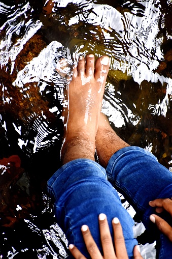Human Foot in water of pond