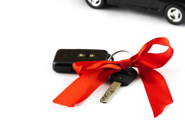 istock Keys with red bow and car as present 1427138193