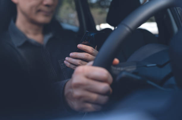 Driver using phone stock photo