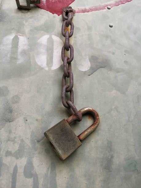 istock An old rusty padlock closed on a massive chain on iron background 1427138611
