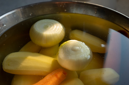 Peeled potatoes, carrots and onions