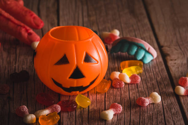 istock Halloween pumpkin basket with candy for children. Selective focus. Copy space. 1427144184