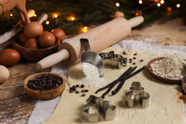 Baking Christmas cookies in rustic kitchen with cookie cutters and dough