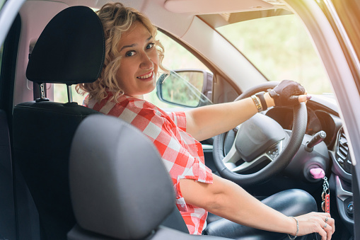 Blonde woman driving a car with a manual transmission