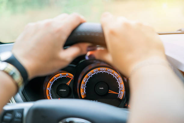 istock Car speedometer and female hands, selective focus 1427192930
