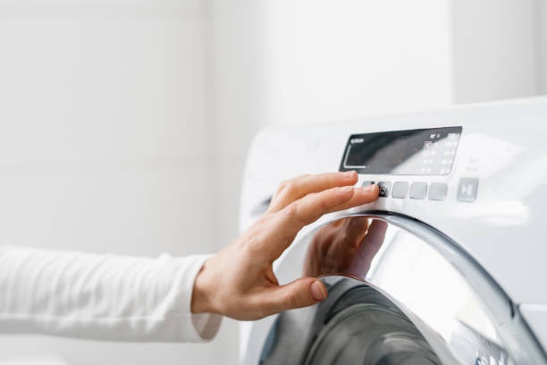 istock female hand press button on washing machine indoors 1427195433