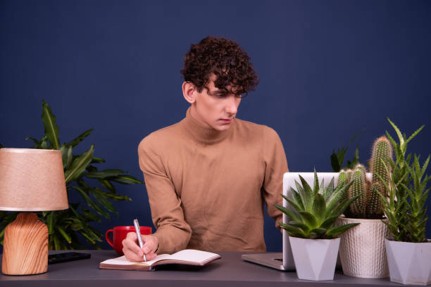 istock A young attractive student is working on a laptop. 1427201505