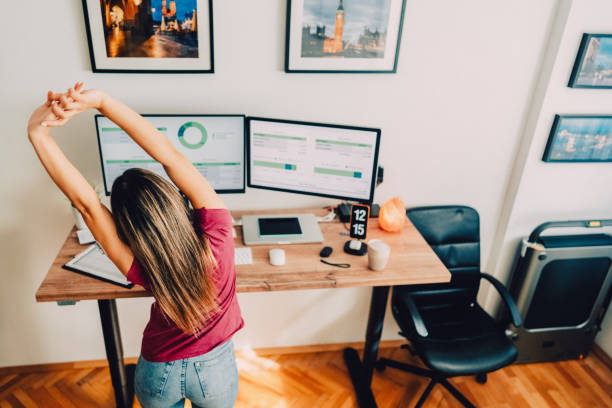 istock Young woman with diabetes working at standing desk 1427204004