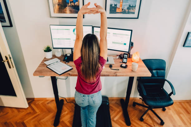 istock Woman at home office is walking on under desk treadmill 1427204225