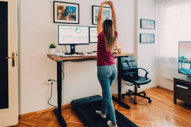 istock Woman at home office is walking on under desk treadmill 1427204520
