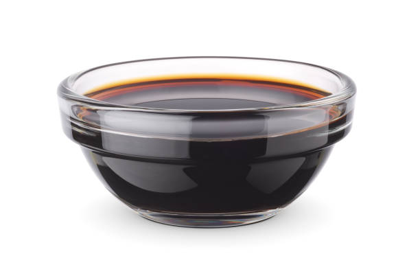 Glass dip bowl with soy sauce isolated on white. Glass dip bowl with soy sauce isolated on white background. Clipping path included. soia sauce stock pictures, royalty-free photos & images