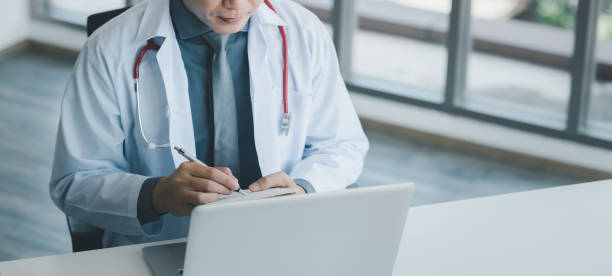 Doctor using online health consulting on computer pc and digital tablet, Tele medical healthcare concept, Banner with copy space stock photo
