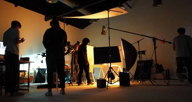 Photo of Production team shooting some video movie for tv commercial with studio equipment set.