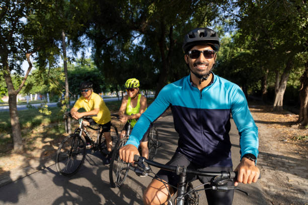 istock Friends leaning on bicycle amidst forest 1427213189