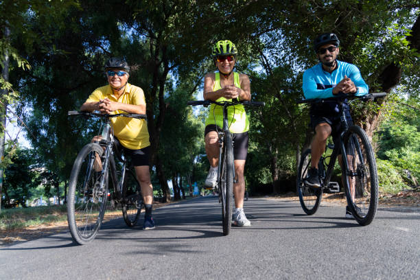 istock Friends leaning on bicycle amidst forest 1427213206