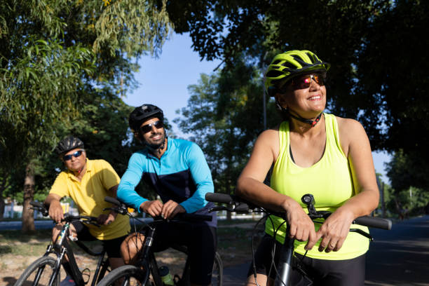 istock Friends leaning on bicycle amidst forest 1427213210