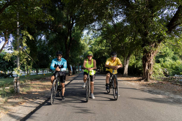istock Friends leaning on bicycle amidst forest 1427213225