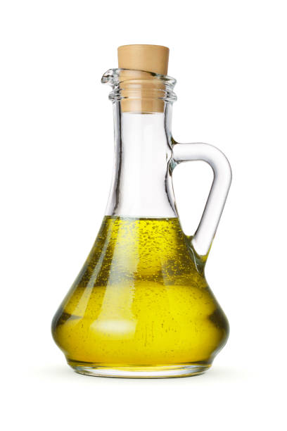 istock Olive oil in glass bottle with cork isolated on white. 1427214163