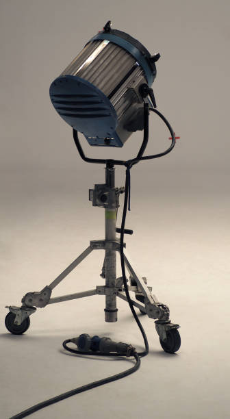 istock Studio spotlight big size equipment on the tripod in a huge studio with green screen background . 1427214743