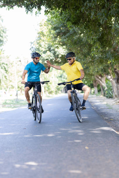 istock Young man and old cyclist having fun riding bicycle outdoors 1427216065