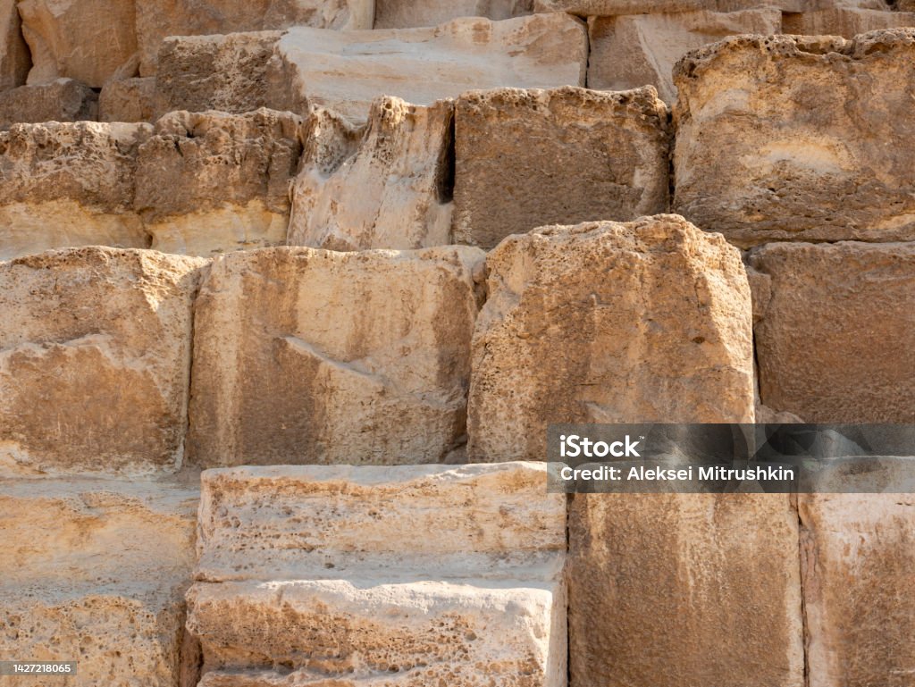 Pyramid of Cheops, the largest of the Egyptian pyramids. Close-up of stone blocks weighing more than 2 tons each. Giza, Cairo, Egypt Pyramid of Cheops, the largest of the Egyptian pyramids. Close-up of stone blocks weighing more than 2 tons each. Giza, Cairo, Egypt. Archaeology Stock Photo