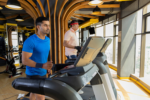 Man in sportswear doing cardio workout at gym