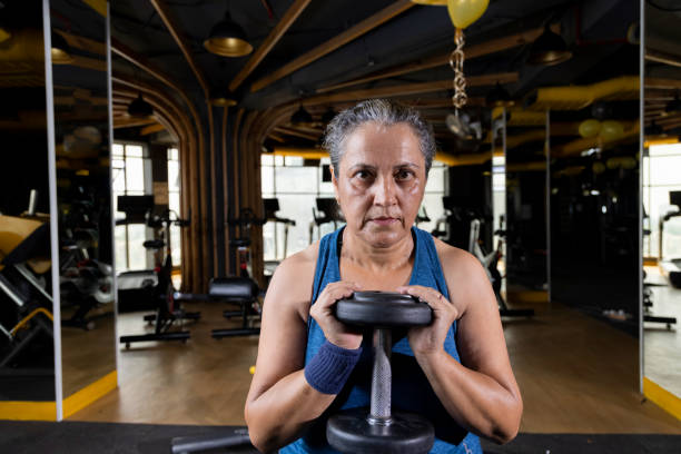 istock Woman lifting weights at the gym 1427220916