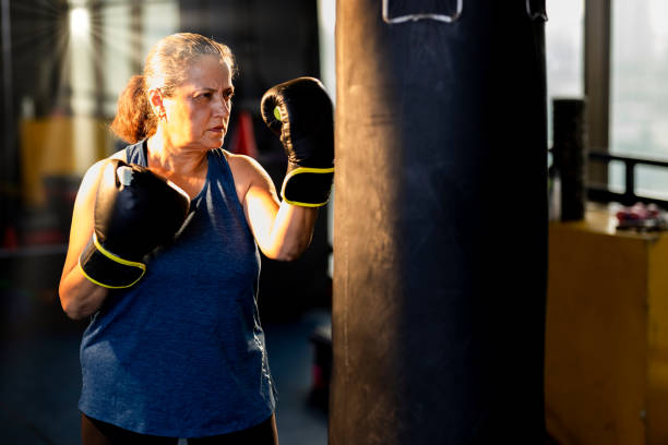 istock Female boxer training with punching bag 1427221002