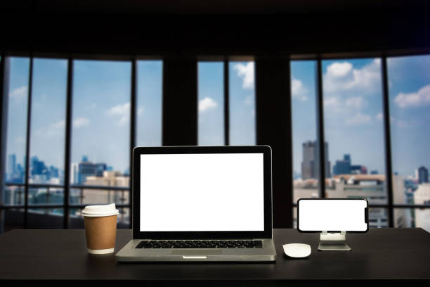 istock Front view workspace with computer, smartphone and tablet on white desk with blurred City background 1427221298