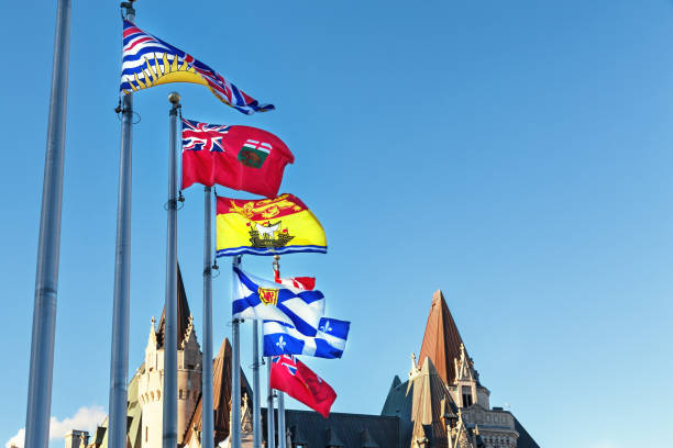 Provincial flags of Canada on Parliament Hill  in Ottawa, Ontario. From front to back the flags represent British Columbia, Manitoba, New Brusnwick, Nova Scotia, Quebec and Ontario provinces stock photo