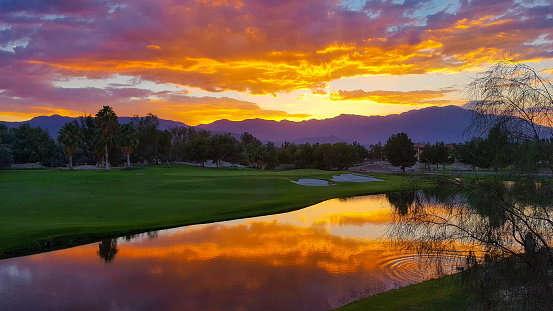 Spectacular colorful sunset and lake reflection at Shadow Ridge in Palm Desert, California