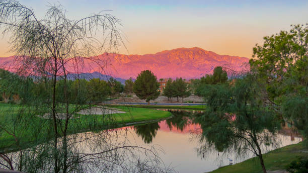 Sunrise in Palm Desert Sunrise over a beautiful lake and Southern California's magnificent mountain ranges, Palm Desert, palm desert pool stock pictures, royalty-free photos & images