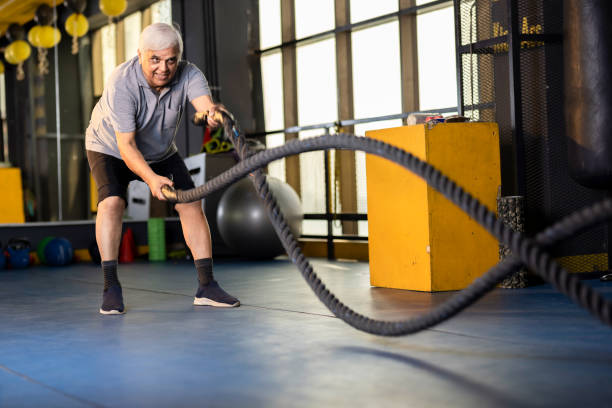 istock senior men training with battle rope in gym gym 1427221807