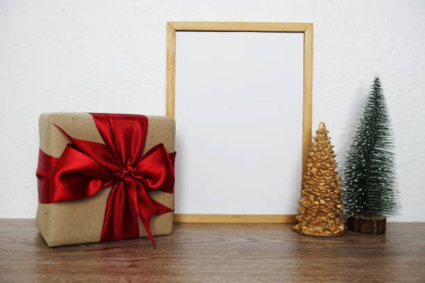 istock Empty mockup with christmas tree and gift box on wooden background 1427223011