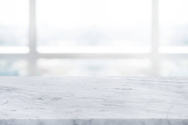 istock Selective focus.Marble table top on blur abstract window glass background. 1427224013