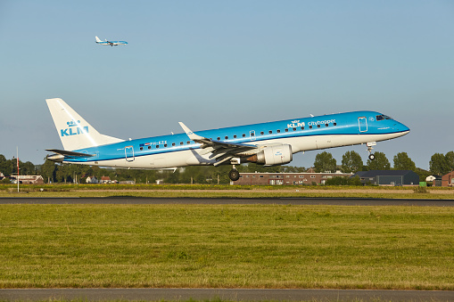 Vijfhuizen, The Netherlands - August, 20, 2022. The Embraer E190STD of KLM Cityhopper with the identification PH-EZE lands at Amsterdam Airport Schiphol (AMS, runway Polderbaan).