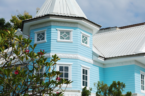 Details of blue colored house with tower in residential district in Bangkok Chatuchak