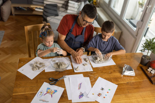 istock Father and kids playing with clay 1427226131