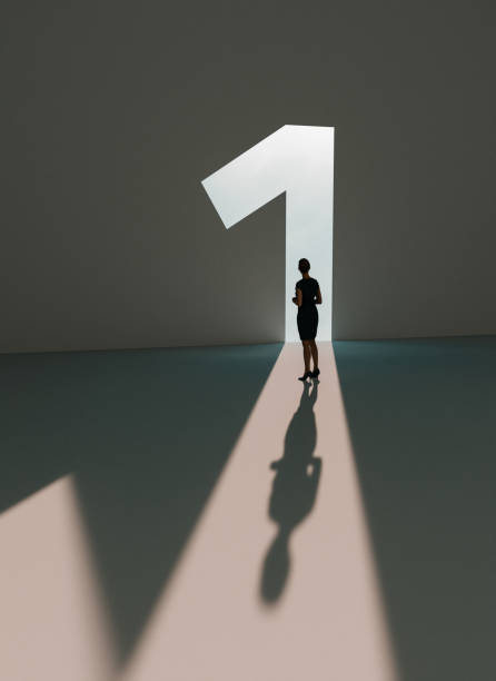 Woman is number one and walks into the light of success stock photo