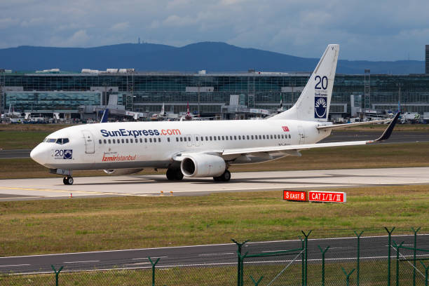 Sunexpress passenger plane at airport. Schedule flight travel. Aviation and aircraft. Air transport. Global international transportation. Fly and flying. Frankfurt, Germany - August 17, 2014: Sunexpress passenger plane at airport. Schedule flight travel. Aviation and aircraft. Air transport. Global international transportation. Fly and flying. sunexpress stock pictures, royalty-free photos & images