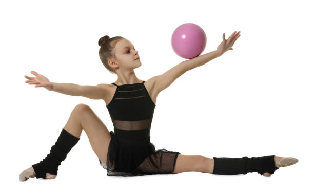 istock Cute little gymnast doing with ball on white background 1427234853