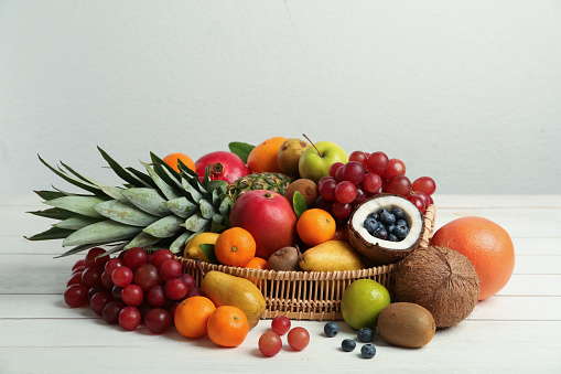 Colorful raw fruits and vegetables varied vegan food, vivid rainbow arrangement full frame background