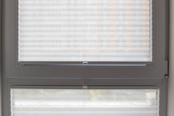 istock Pleated blinds close up on the window in the interior 1427237087