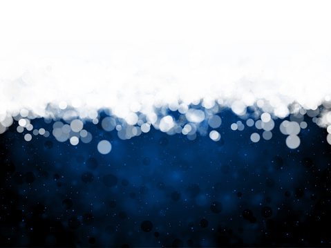 White colored fog or snow or smoke and glittering circles at the top of illuminated glowing dark blue horizontal backgrounds. Can be used as Xmas , New Year day celebrations background, wallpapers, gift wrapping sheets, posters, banners ad greeting cards. Small glitter like or glittery dots shining all over.