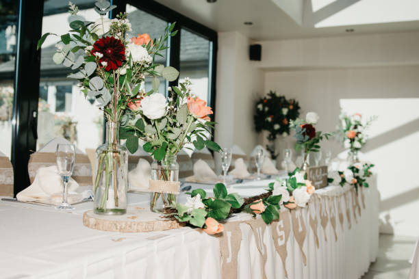 istock Rustic Wedding Reception Top Table seating with glasses, cutlery and dishes 1427242330
