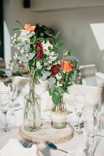 istock Rustic Wedding Reception Top Table seating with glasses, cutlery and dishes 1427242917