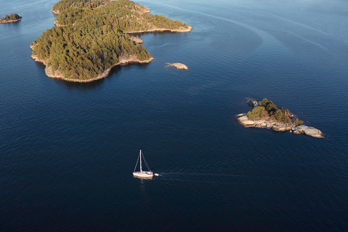 A sailboat among islands of the Stockholm archipelago in Värmdö municipality, Sweden.