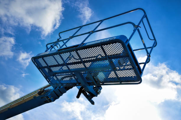 istock Industrial boom lift basket against a blue sky. 1427245867